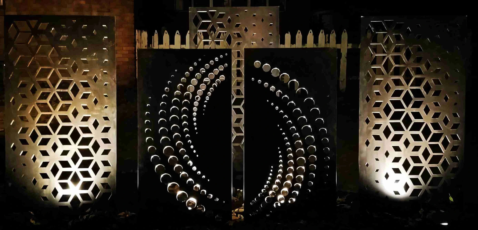 Decorative metal panels with geometric patterns on a dark background