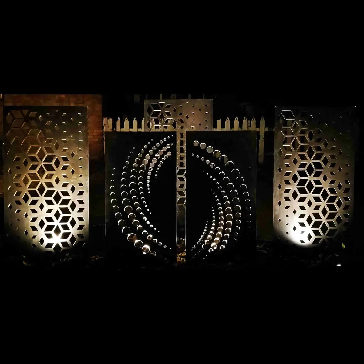 Decorative metal screens with geometric patterns on a dark background