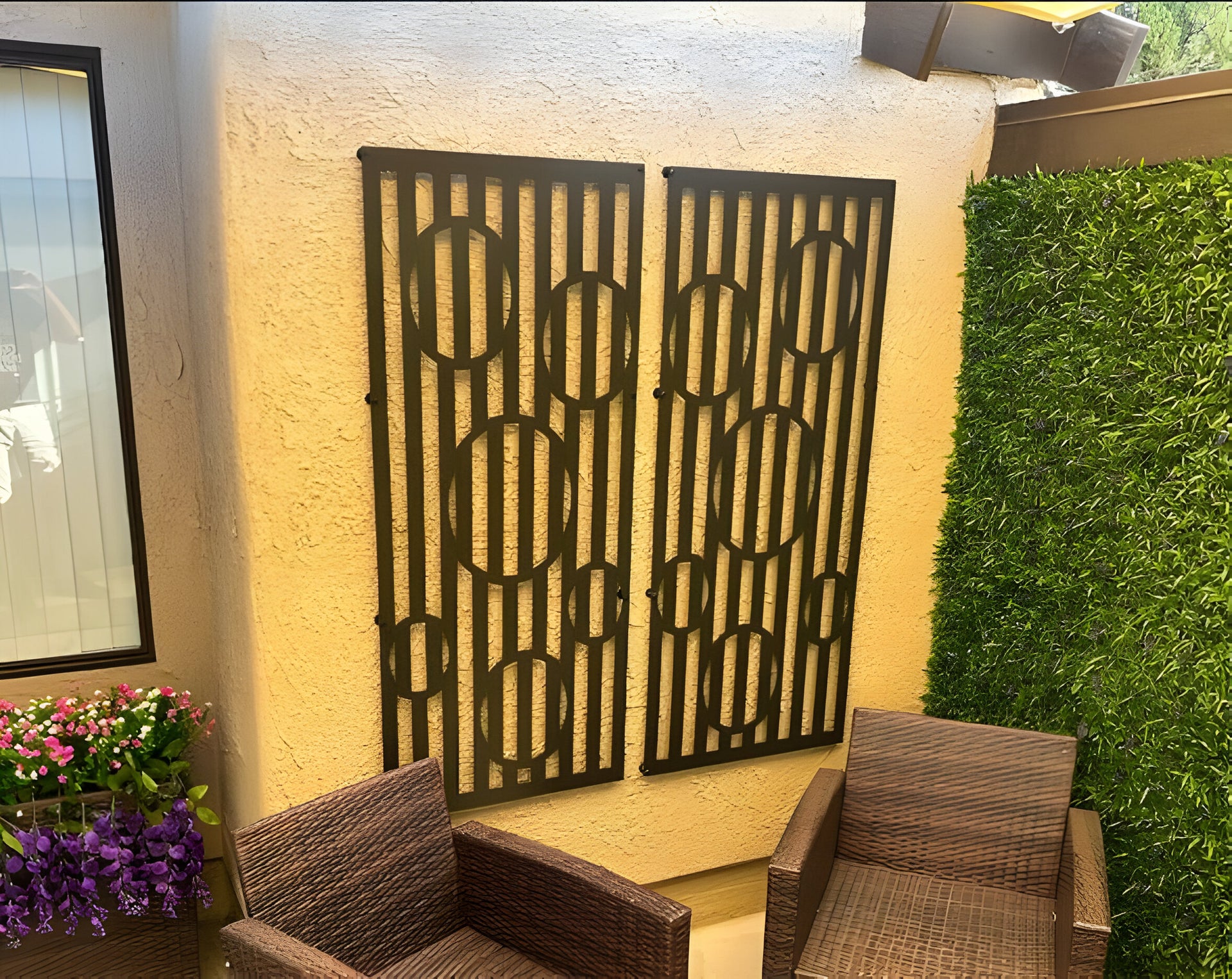 Two Decorative wall panels placed on a yellow surface for outdoor decor