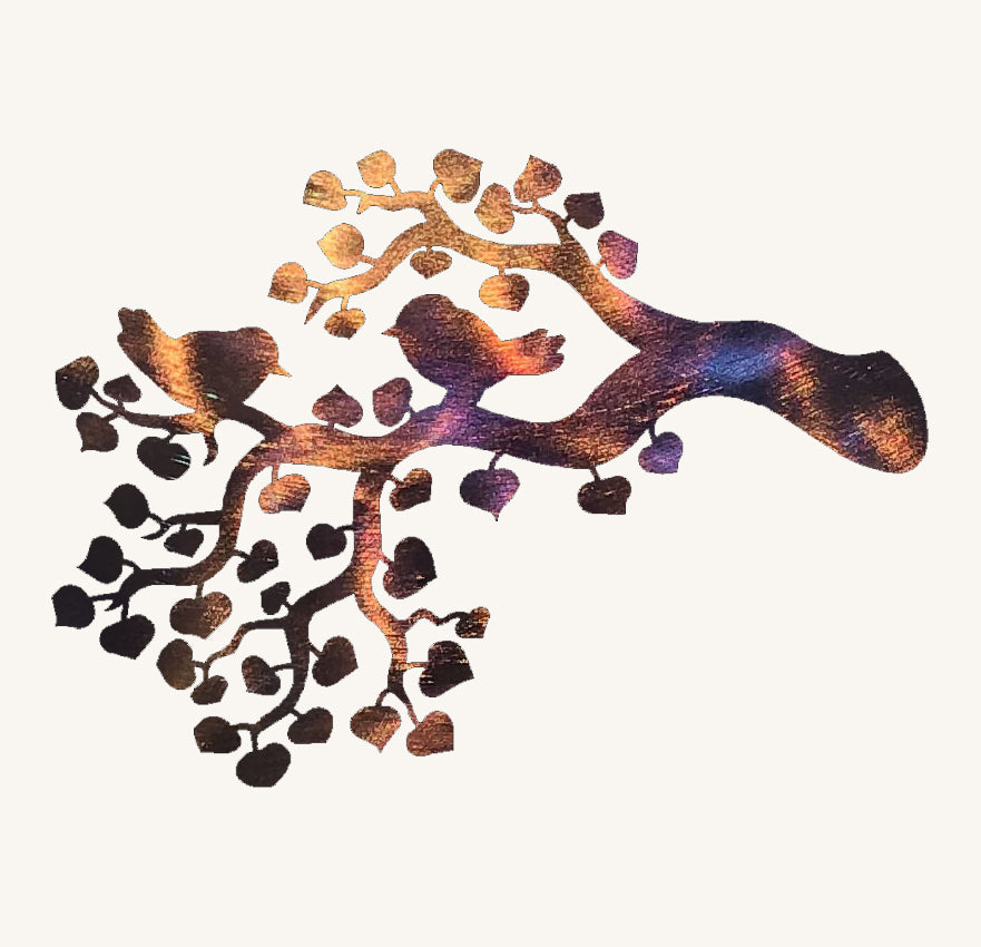 Decorative metal art piece with birds on a branch on a white background