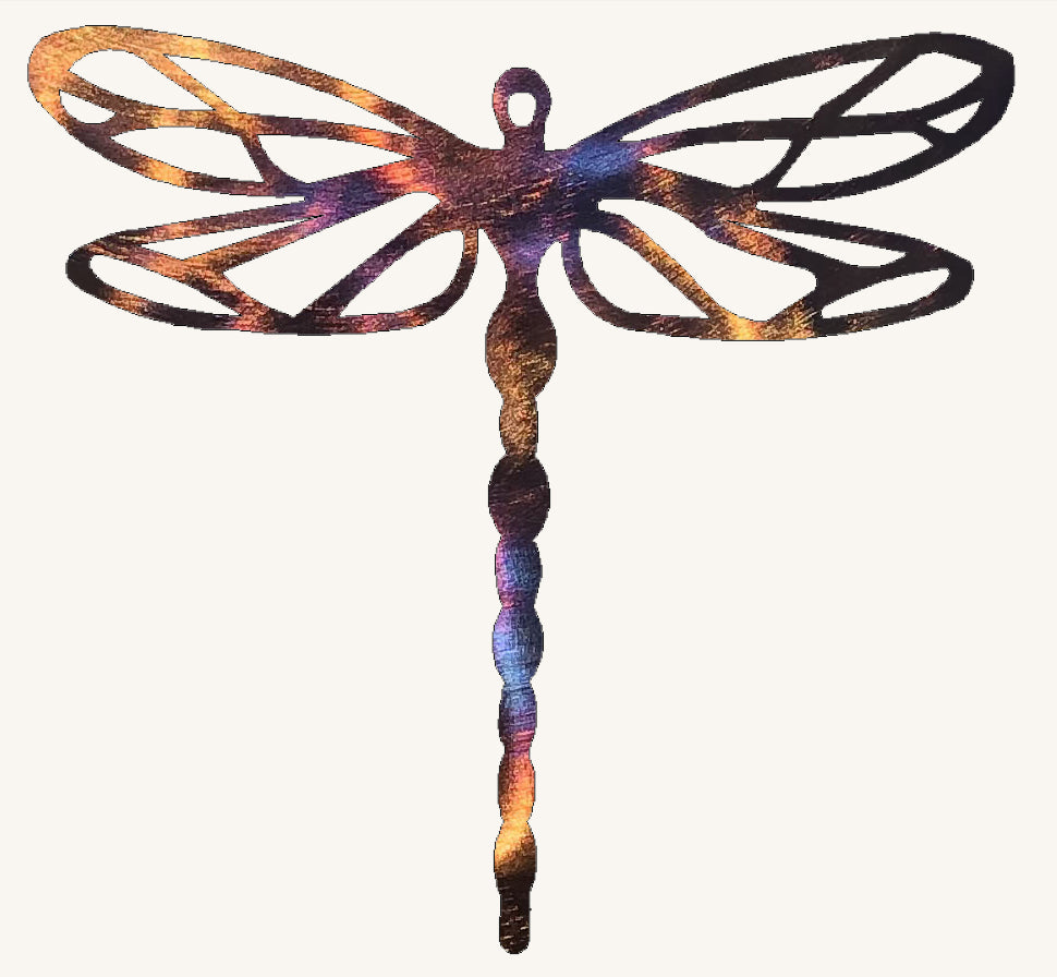 Metallic dragonfly sculpture with a multicolored design on a white background