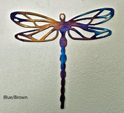 Metal dragonfly sculpture with blue and brown colors on a light gray background