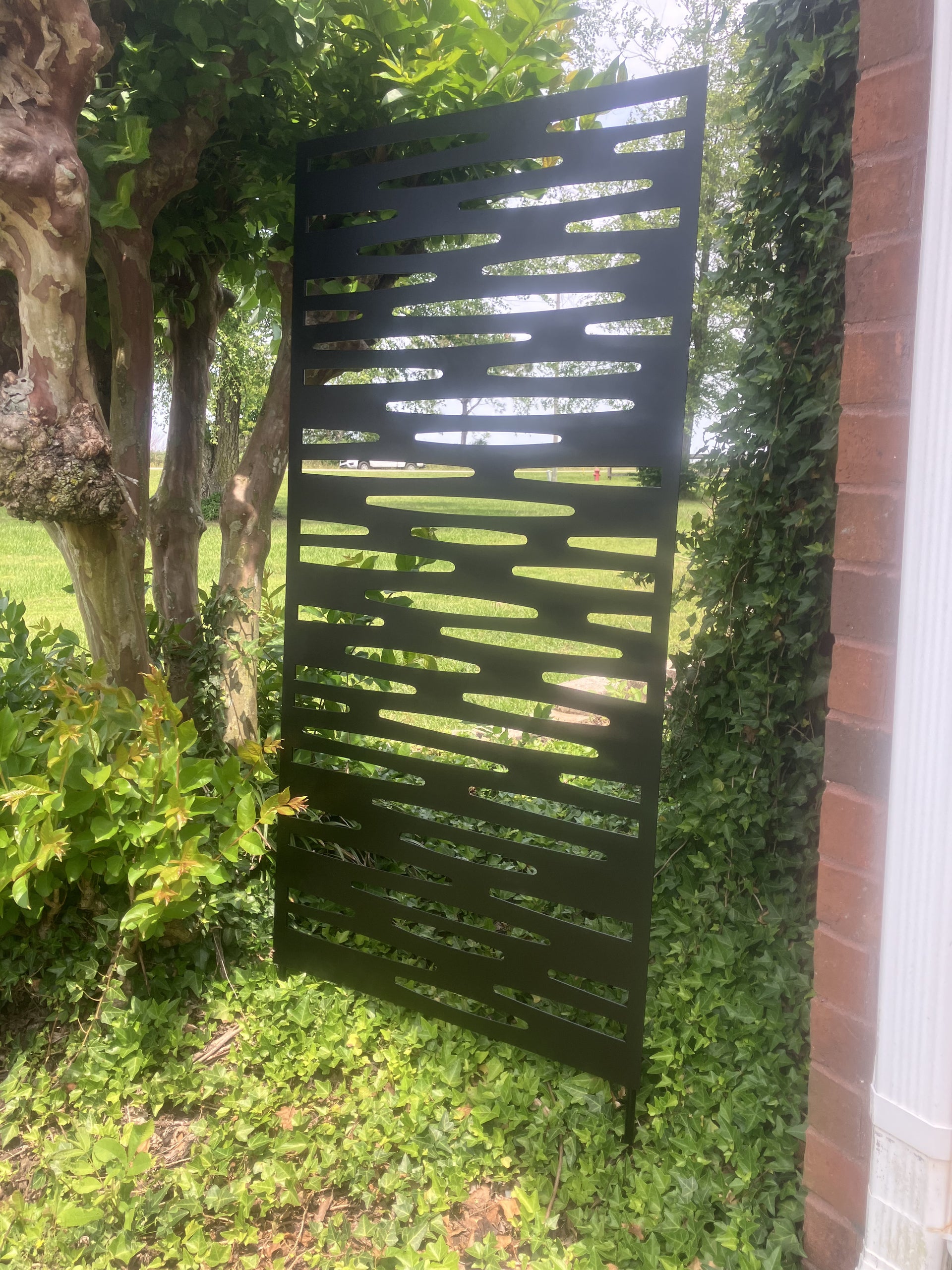 Decorative metal screen in a garden setting