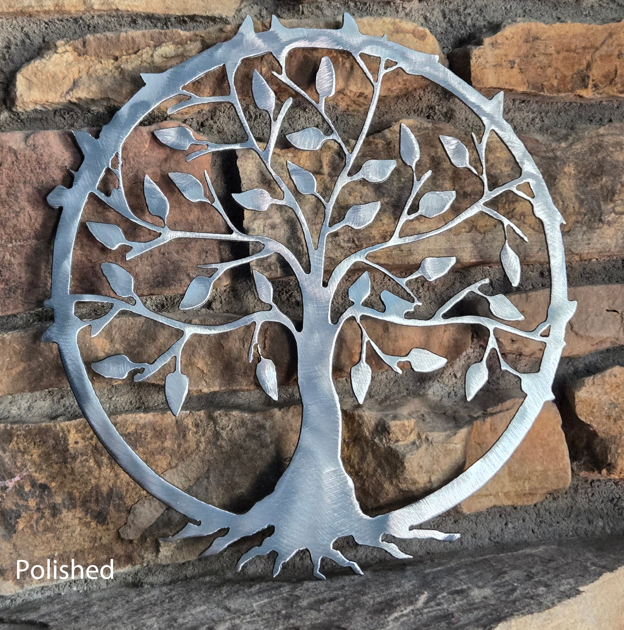 Metal tree wall art on a stone background