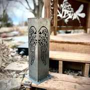Metal decorative pillar with cut-out design on a wooden bench outdoors