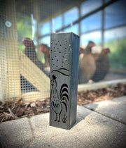 Garden Column Pillar with rooster design on a stone surface