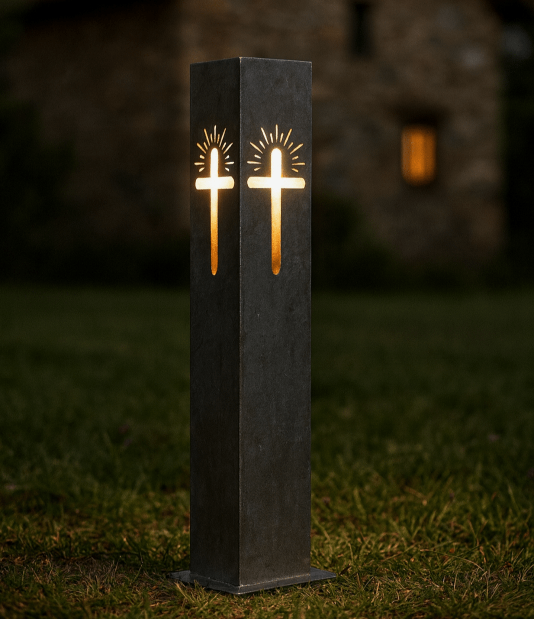 Decorative Garden Column Pillar with cross design on a grassy area at night.