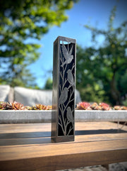 Outdoor Decorative Column with bird designs on a wooden surface outdoors
