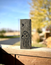 Metallic Garden Pillar with engraved design on a wooden surface outdoors