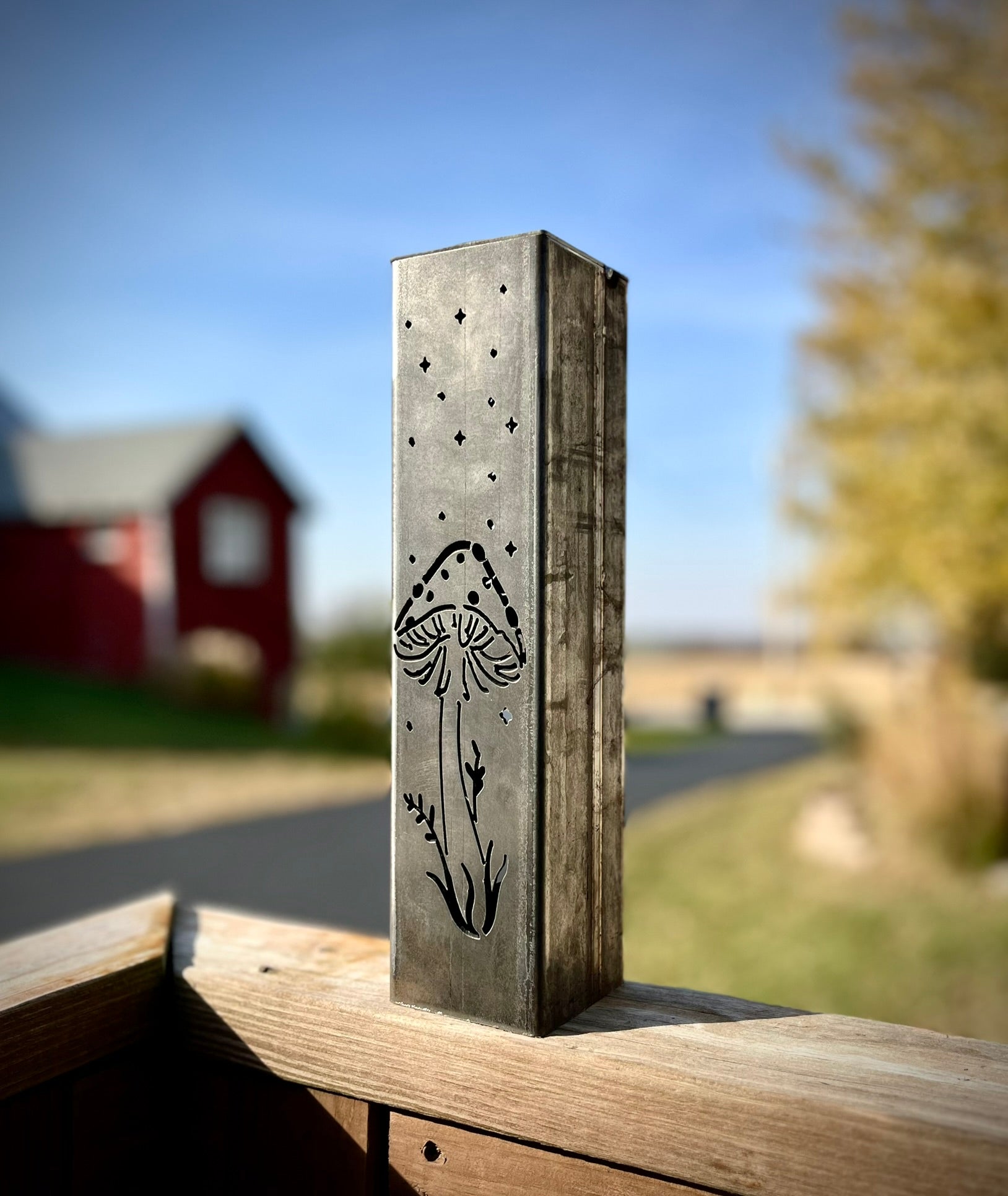 Garden Pillar with mushroom design against a blurred outdoor background