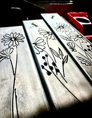 Outdoor Decorative Pillars with black floral designs on a reflective background