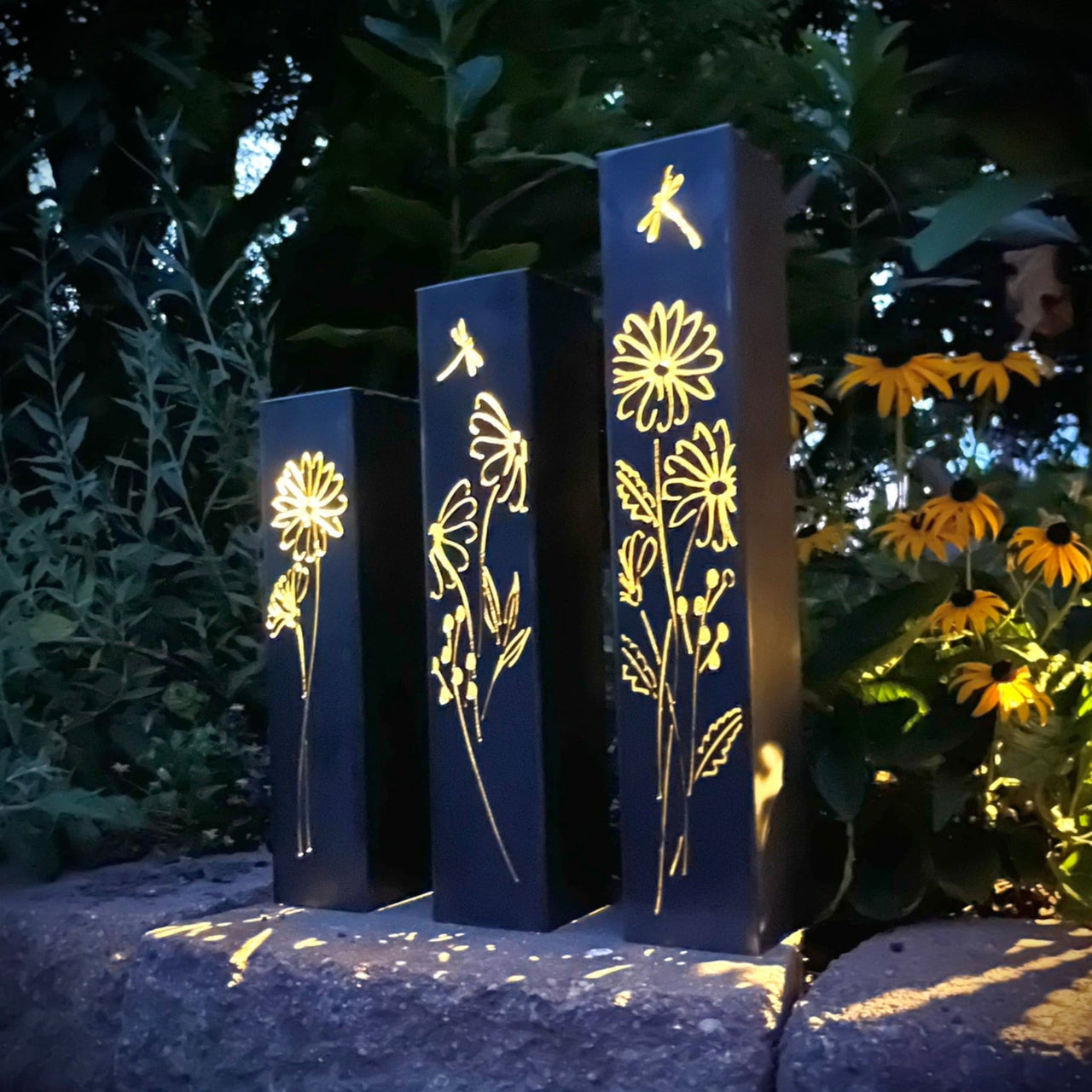 Outdoor Decorative Pillars with floral patterns in a garden setting