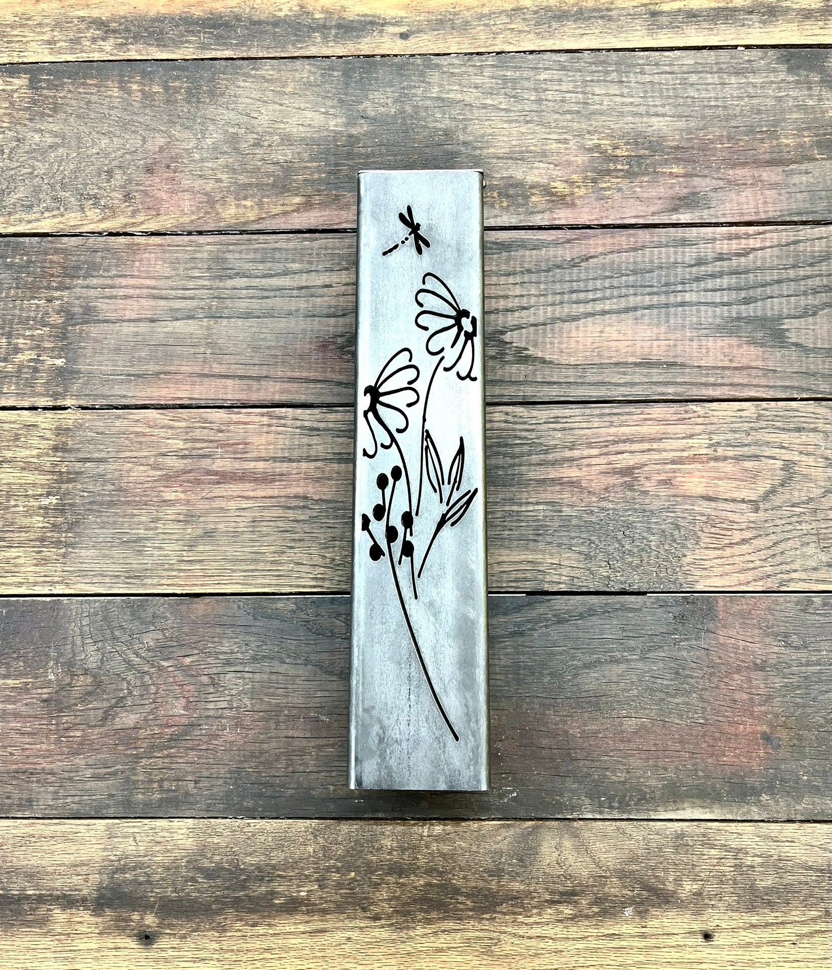Outdoor Decorative Pillar with floral designs on a wooden surface