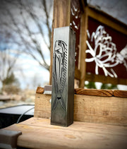 Garden pillar with fish design on a wooden surface outdoors