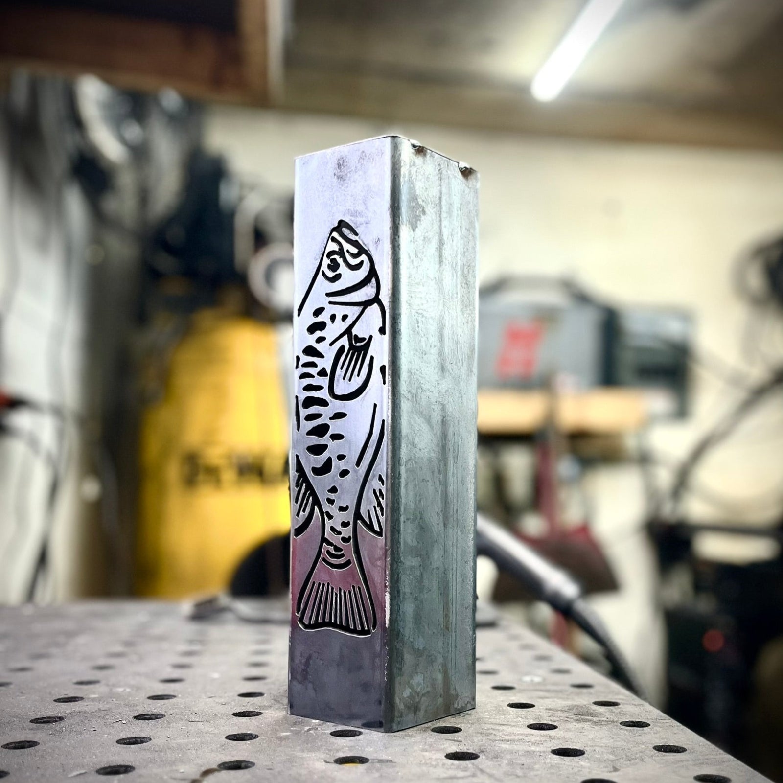 Garden column pillar with fish design on a workshop table