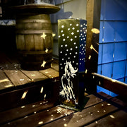 Decorative Garden Pillar with horse design on a wooden deck at night