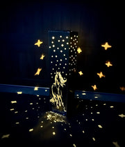 Decorative Garden Pillar with star patterns and a horse design on a dark background
