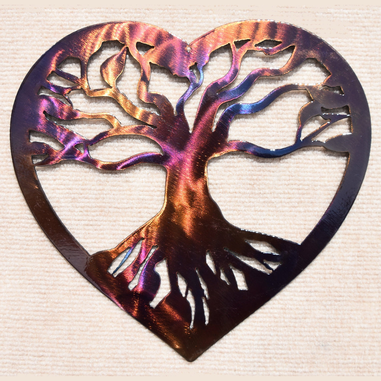 Metallic tree of life design in a heart shape on a textured beige background