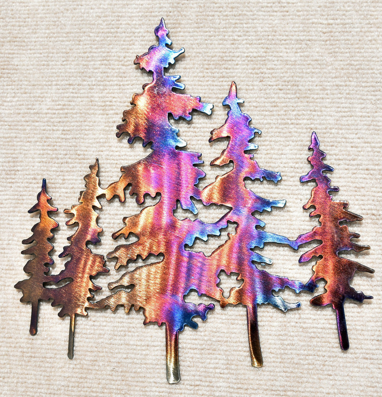 Metallic tree-shaped cutout on a textured beige background