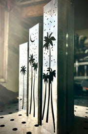 Outdoor garden columns with palm tree and moon designs on a wooden surface.with palm tree and moon designs on a workshop background