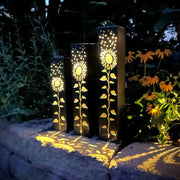 Decorative garden pillars with sunflower patterns on a garden setting